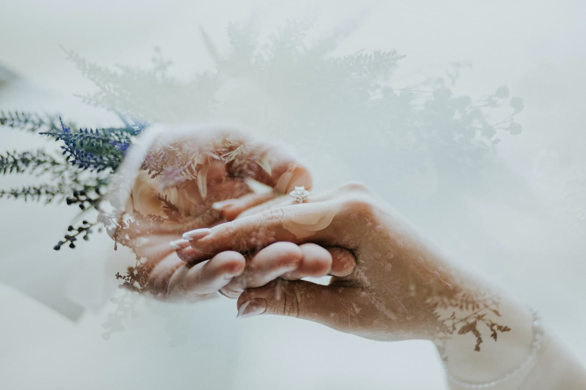 Two hands holding each other in a wedding ceremony